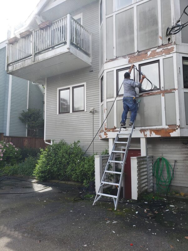 Power washing before painting your home’s exterior.