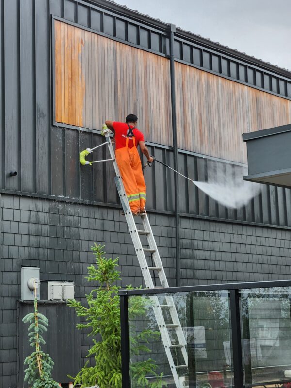 Power washing before painting your home’s exterior.